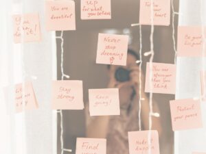 Mirror with lots of post it notes with affirmations
