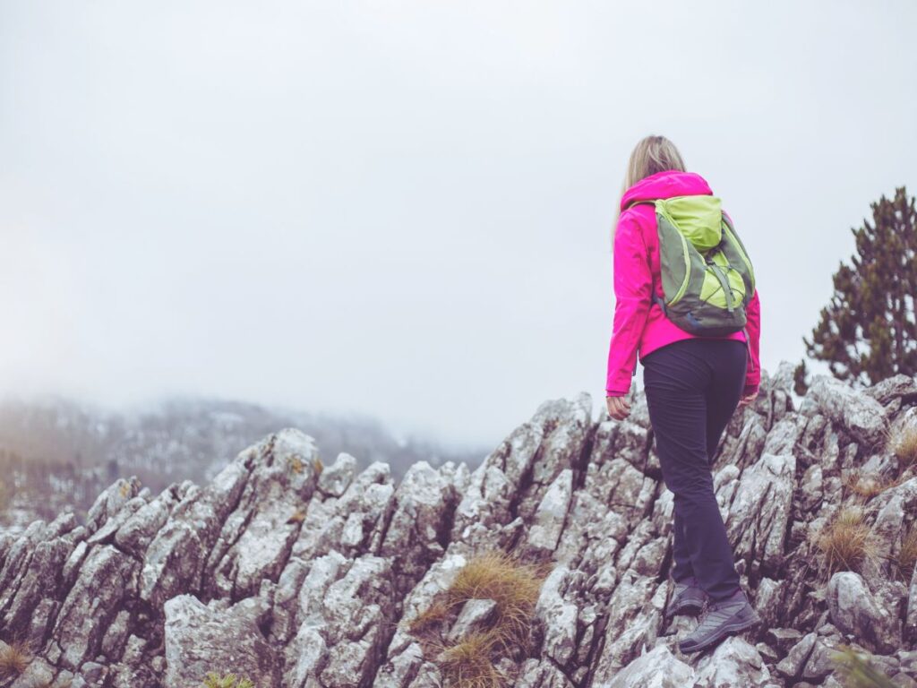 A woman being brave and climbing a mountain