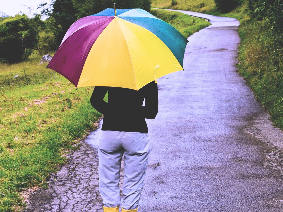A woman with an umbrella in the rain - a sign of resilience