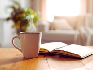 Coffee cup, plant and journal